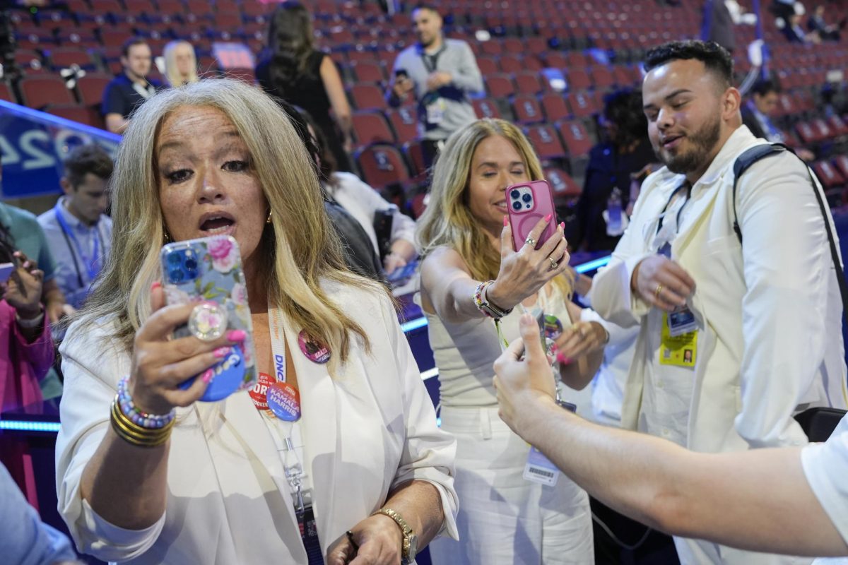 Content creators Kerry Robertson, Sari Beth Rosenberg and Juan Acosta Macias create content during the Democratic National Convention at the United Center in Chicago, Aug. 22, 2024. 