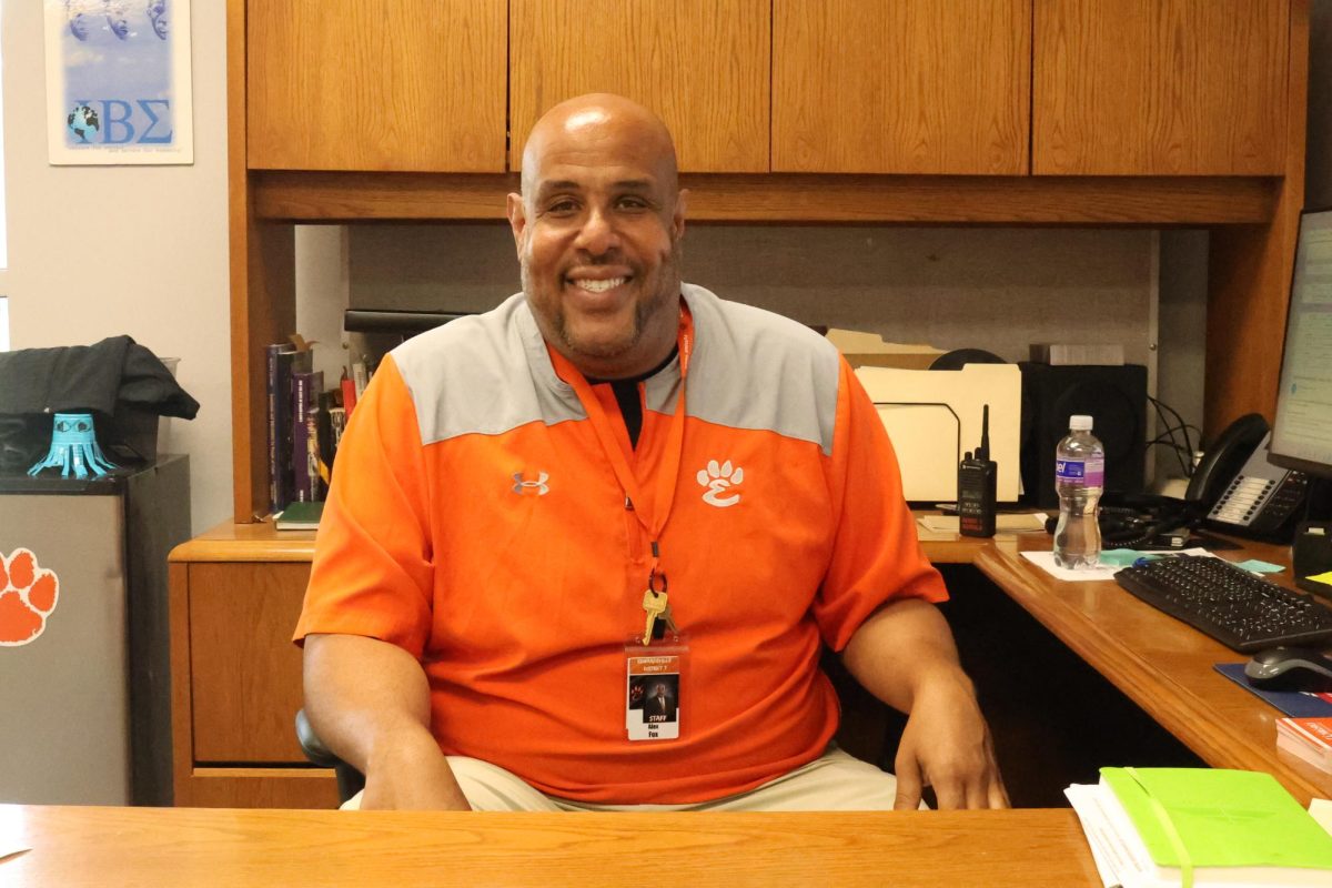 Mr. Fox poses at this desk in his office, which he moved into this year.