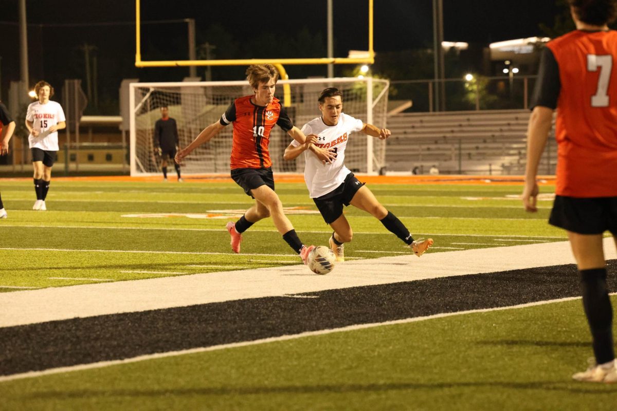 Senior Owen Mahler battles for the ball during the Orange and Black scrimmage Aug. 22.