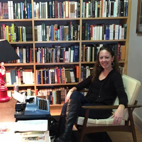 Cara Lane sitting in her at-home library