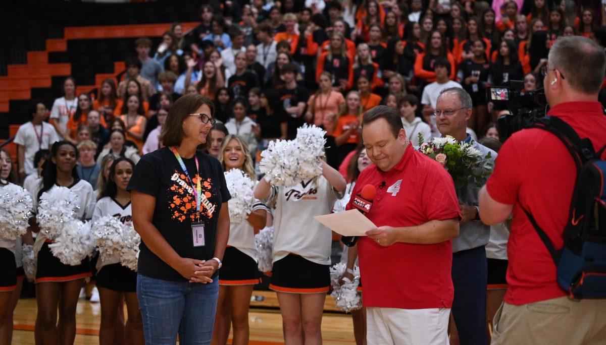 Special education teacher Mrs. Clausen stands with KMOV 4 host Matt Chambers to receive her award during the pep rally Aug. 23.