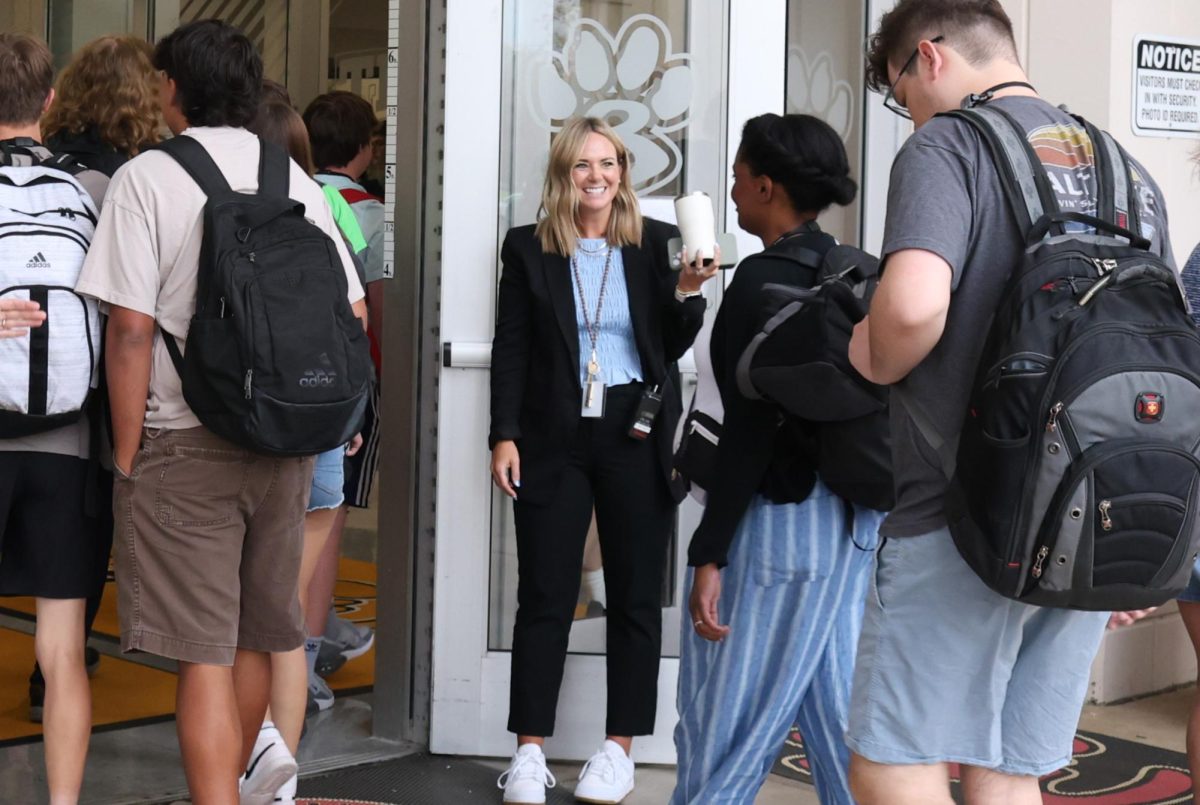 Katelyn Richert greets students with a smile at the door in the morning