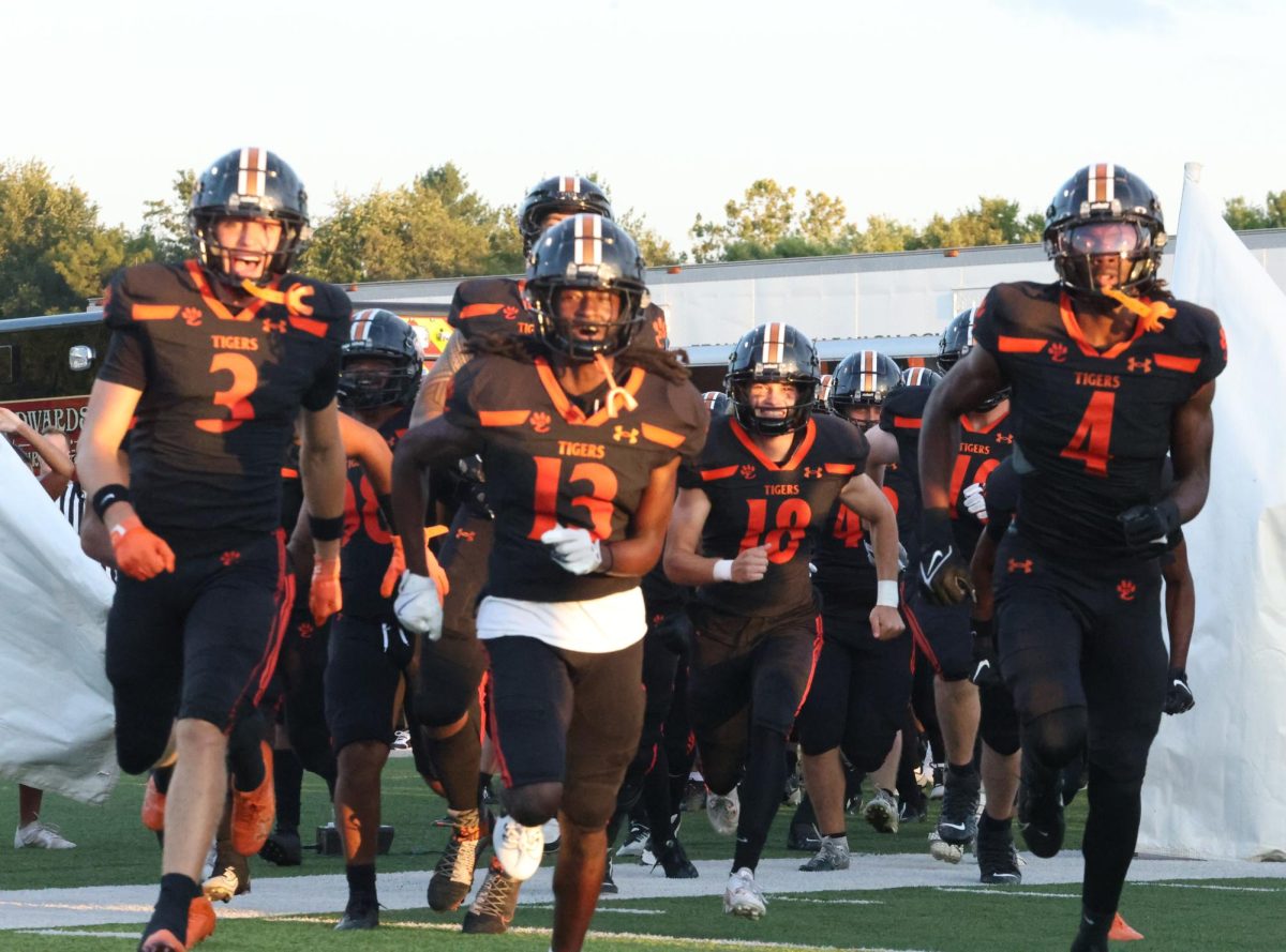 Tigers run through banner at start of game