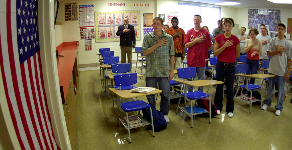 High schoolers recite the Pledge of Allegiance before school Sept. 10, 2002.