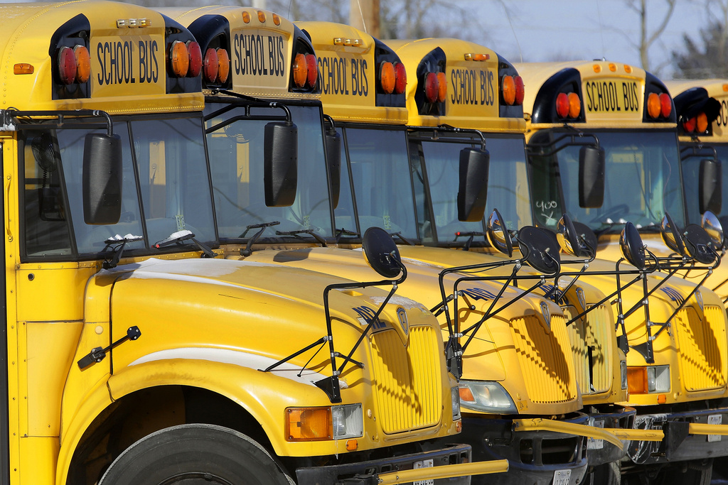 Public school buses are parked in Springfield, Ill., on Jan. 7, 2015. (AP Photo/Seth Perlman, File)