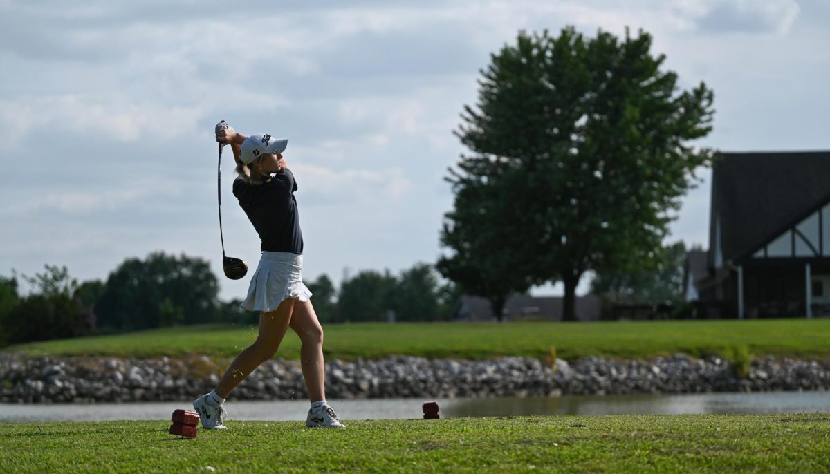 Junior Parker Burns follows through her swing at the JT Invite on Aug. 24.