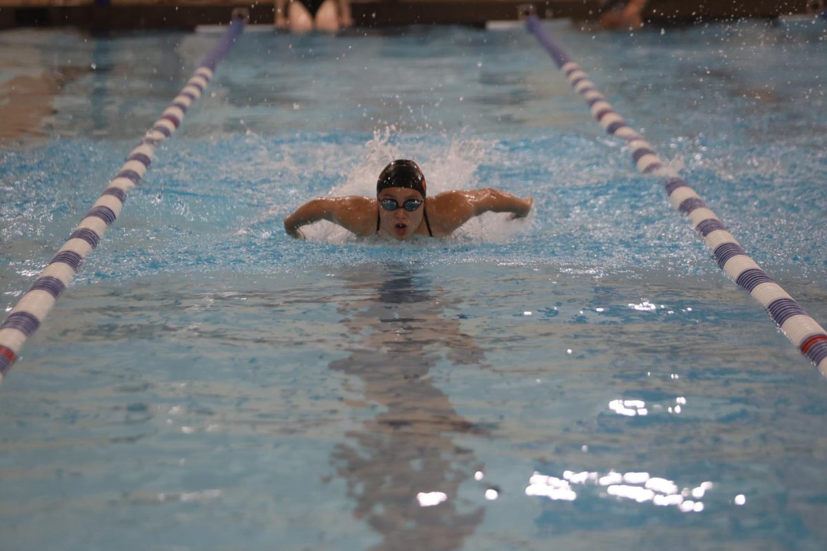 Senior Karis Chen comes up for breath during the 100-meter breaststroke during the meet against Glenwood