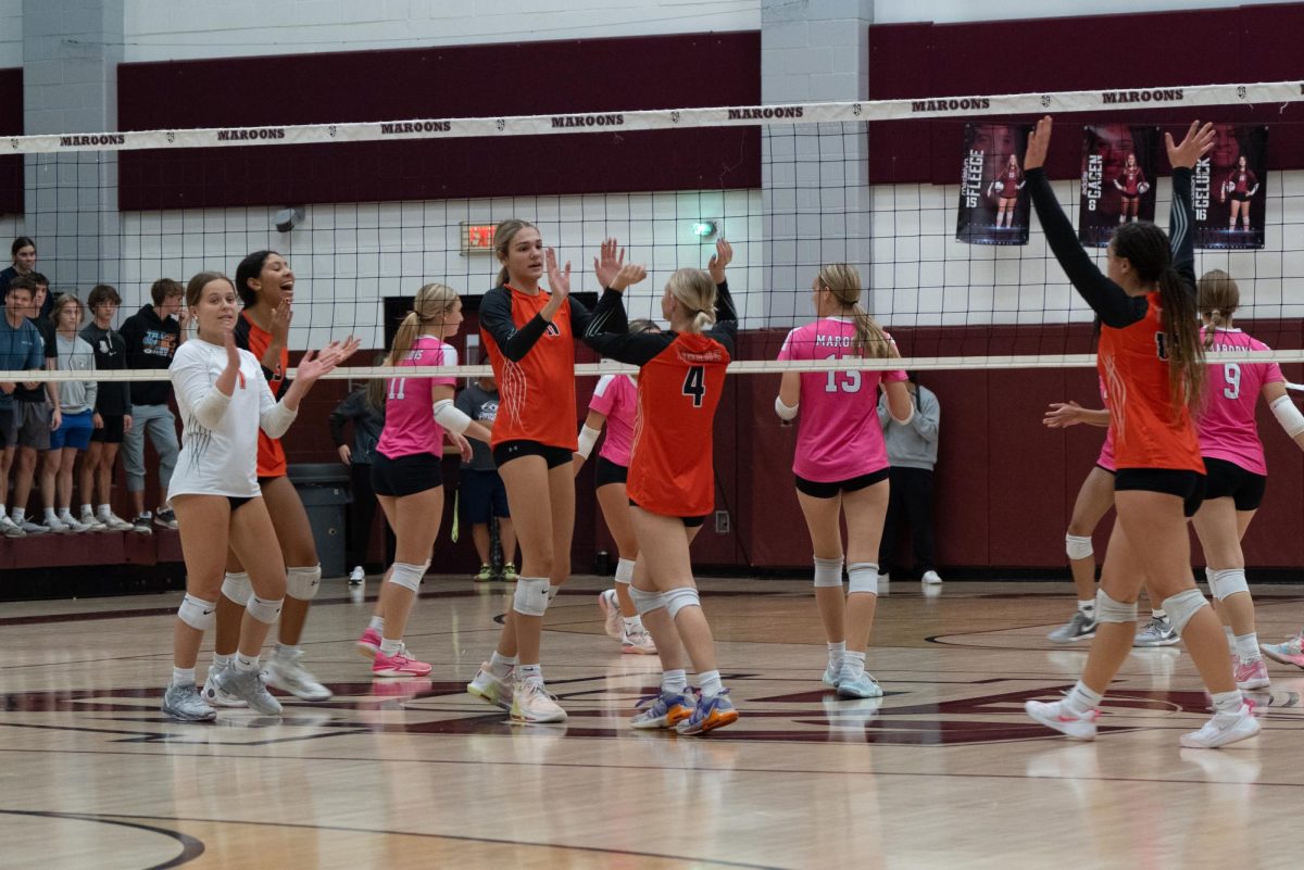 The Edwardsville girls volleyball team celebrates after winning a point against Belleville West Oct. 24.