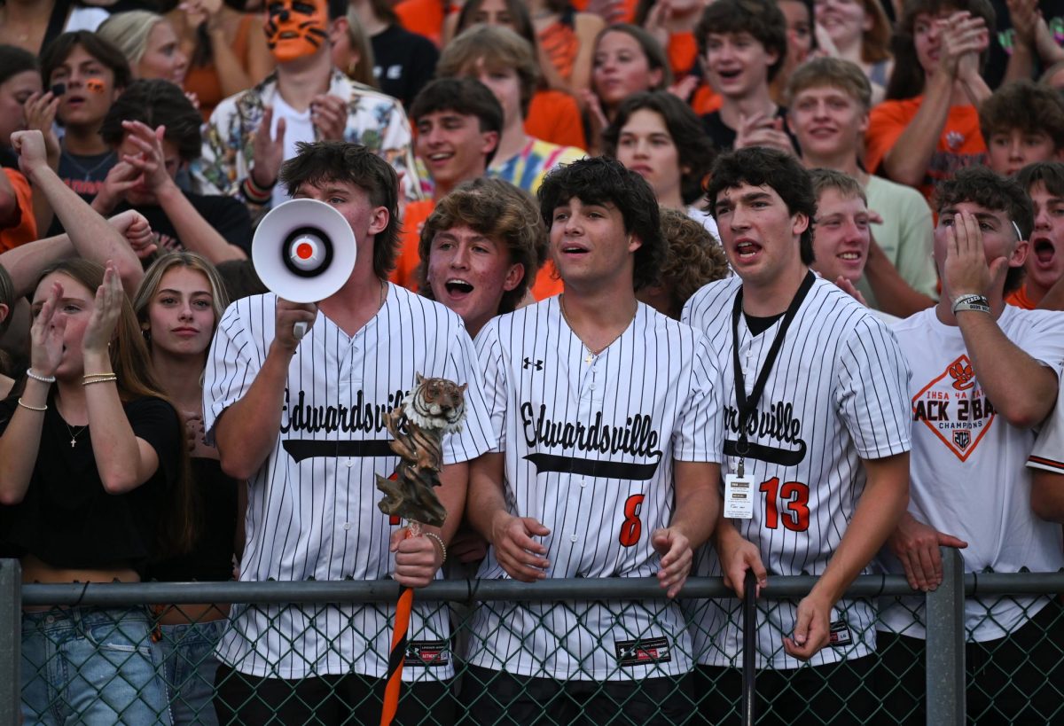 Seniors cheer in the Orange Rush section at the Orange and Black football scrimmage Aug. 23.