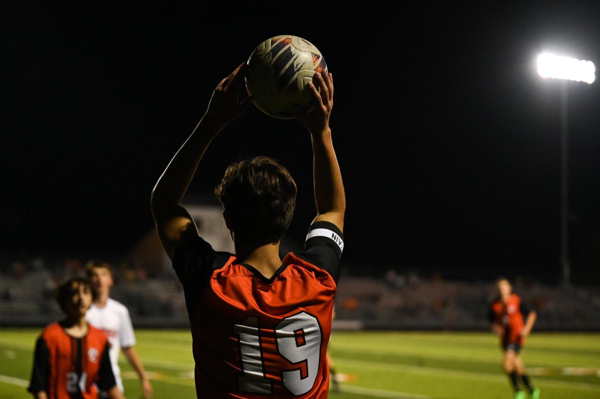 Senior Henry Vivian throws the ball from the sideline during the Orange and Black scrimmage Aug. 22.