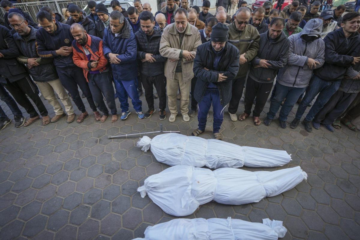 Palestinian mourners pray over the bodies of a family killed in an Israeli airstrike in Gaza, Jan. 12.