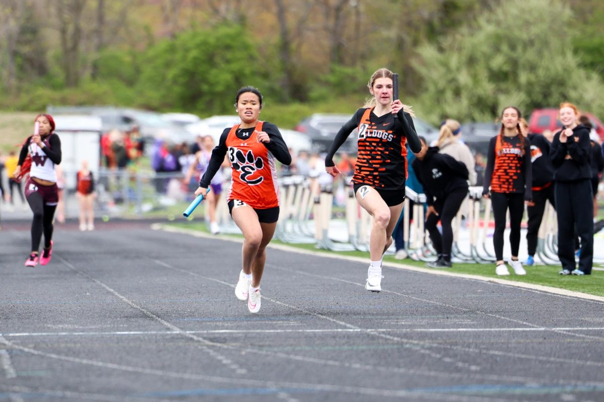 EHS track runner races against opposing team, Triad.