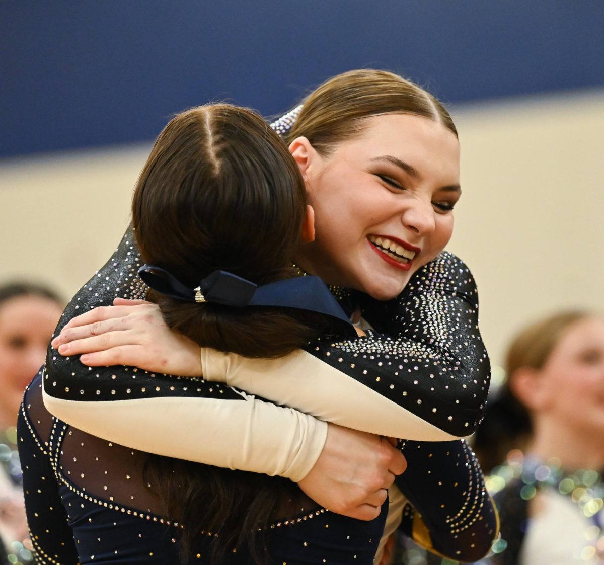 Senior Josie Rutledge celebrates with her teammate after the team's performance.