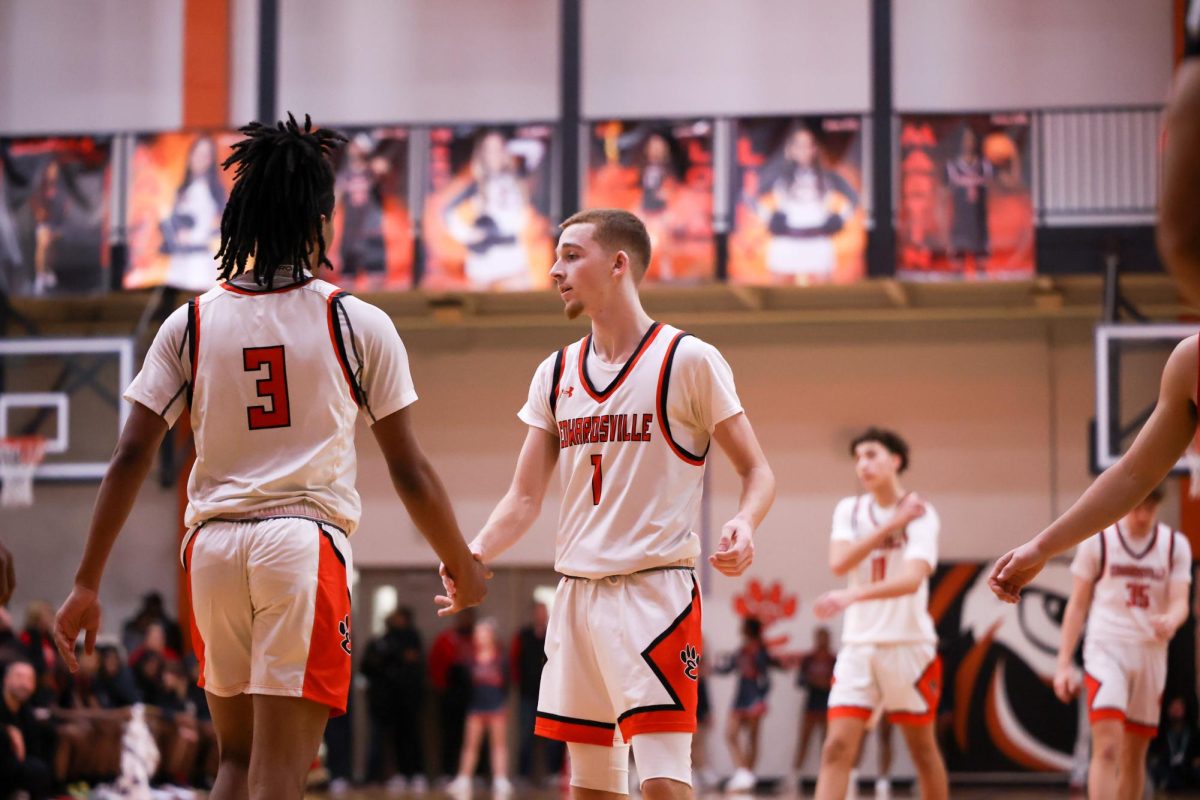 Senior Herb Martin high-fives Bryce Pryor as Pryor prepares to shoot free-throws.