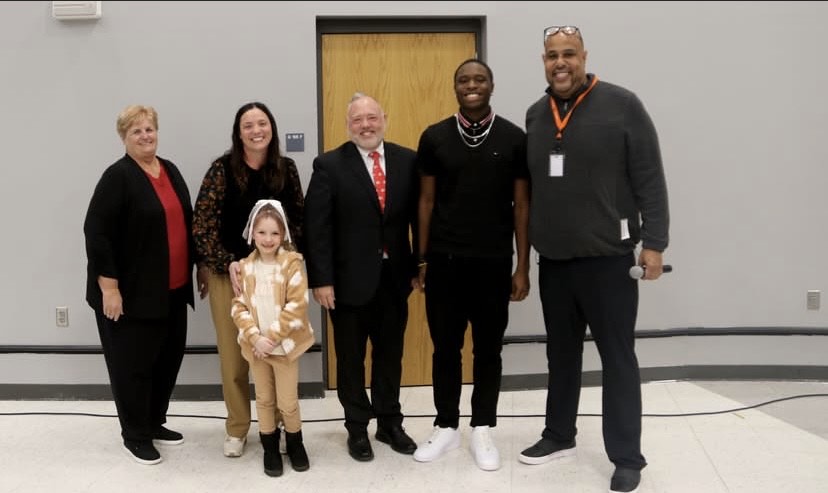 Members of the School Board pictured with two Cane's Students of the month.