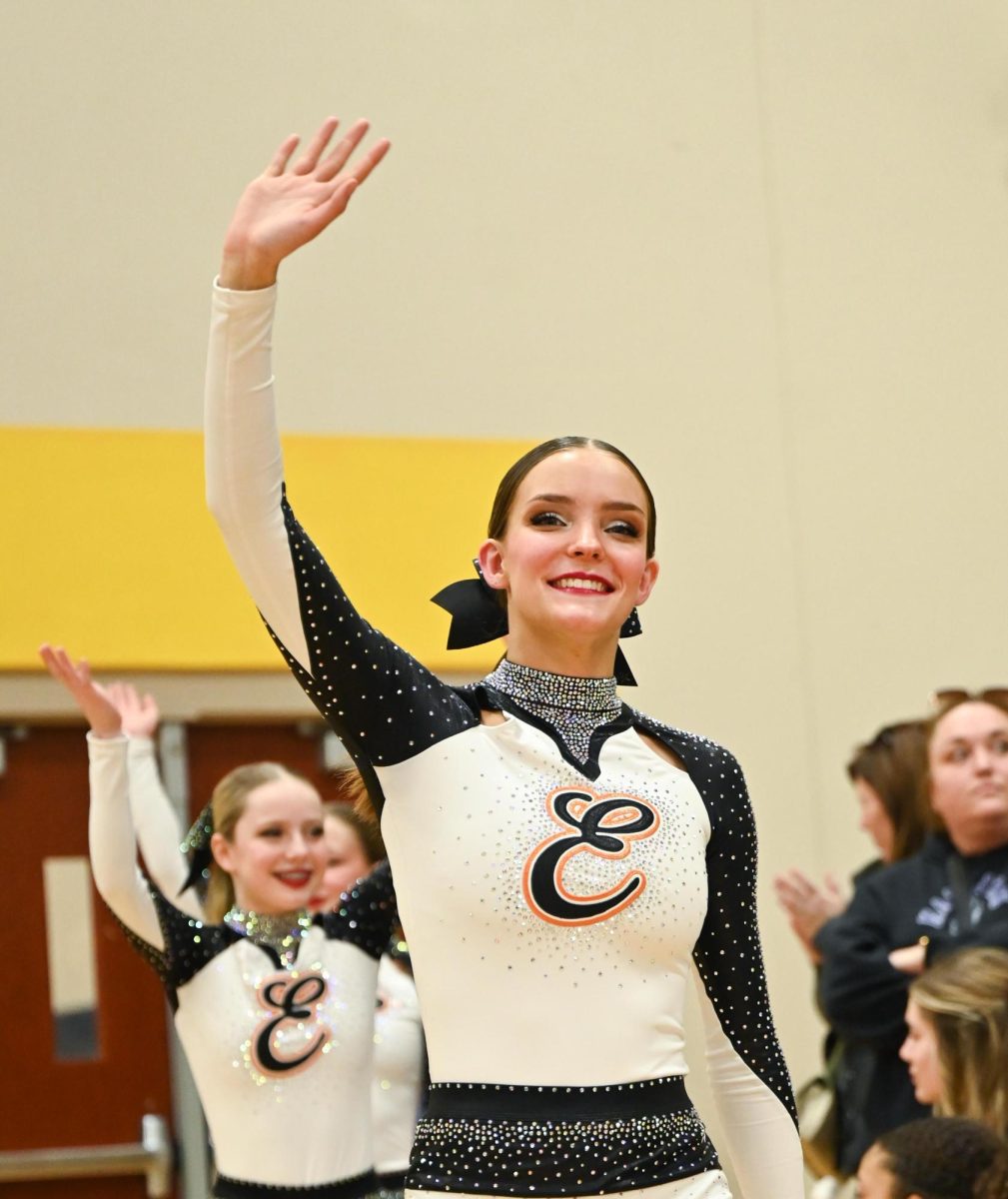 Senior Quinn David waves to the crowd during the Southwestern Conference competition Jan. 26.