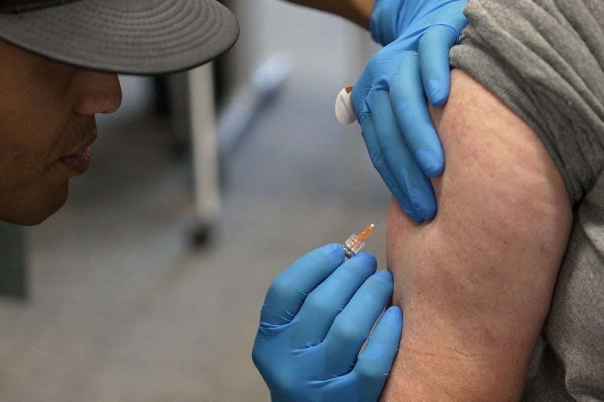 Matt Caldwell, left, a Lubbock Fire Department official, administers a measles, mumps and rubella vaccine to Clair May, 61, at the Lubbock Health Department, Feb. 26, 2025, in Lubbock, Texas.