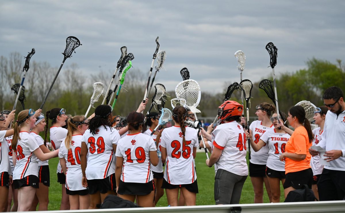 The team huddles during a loss to O'Falon April 9.